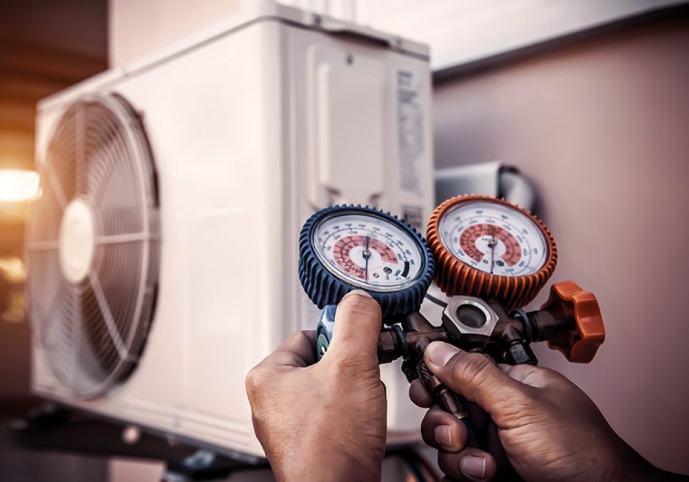 Air repair mechanic using measuring pressure gauge equipment for
