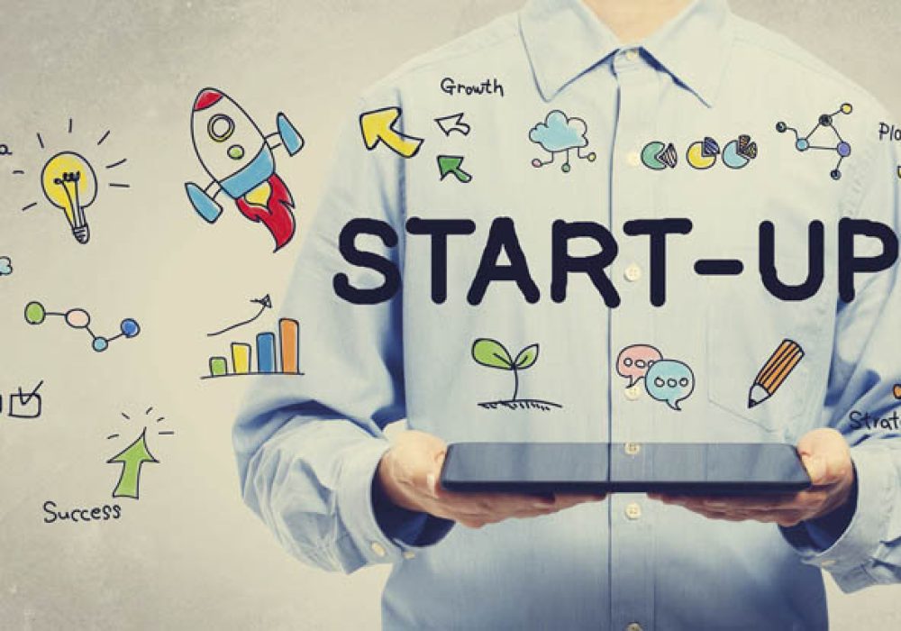 Start-up concept with young man holding a tablet